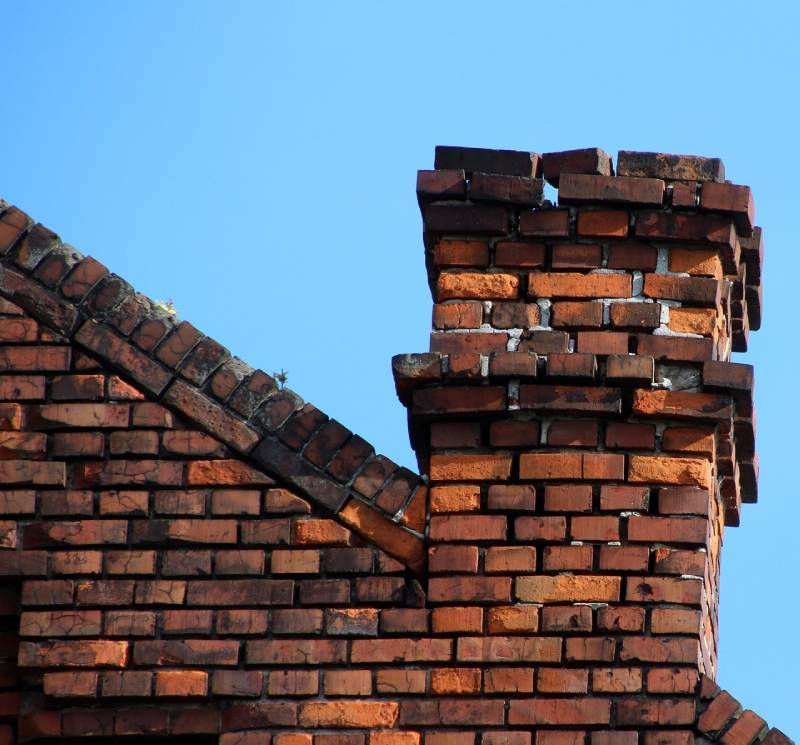 Damaged chimney on an Scio Township home showing cracks and missing mortar